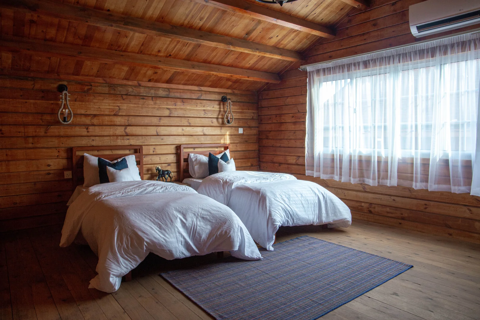 A bright bedroom arranged with separate beds
